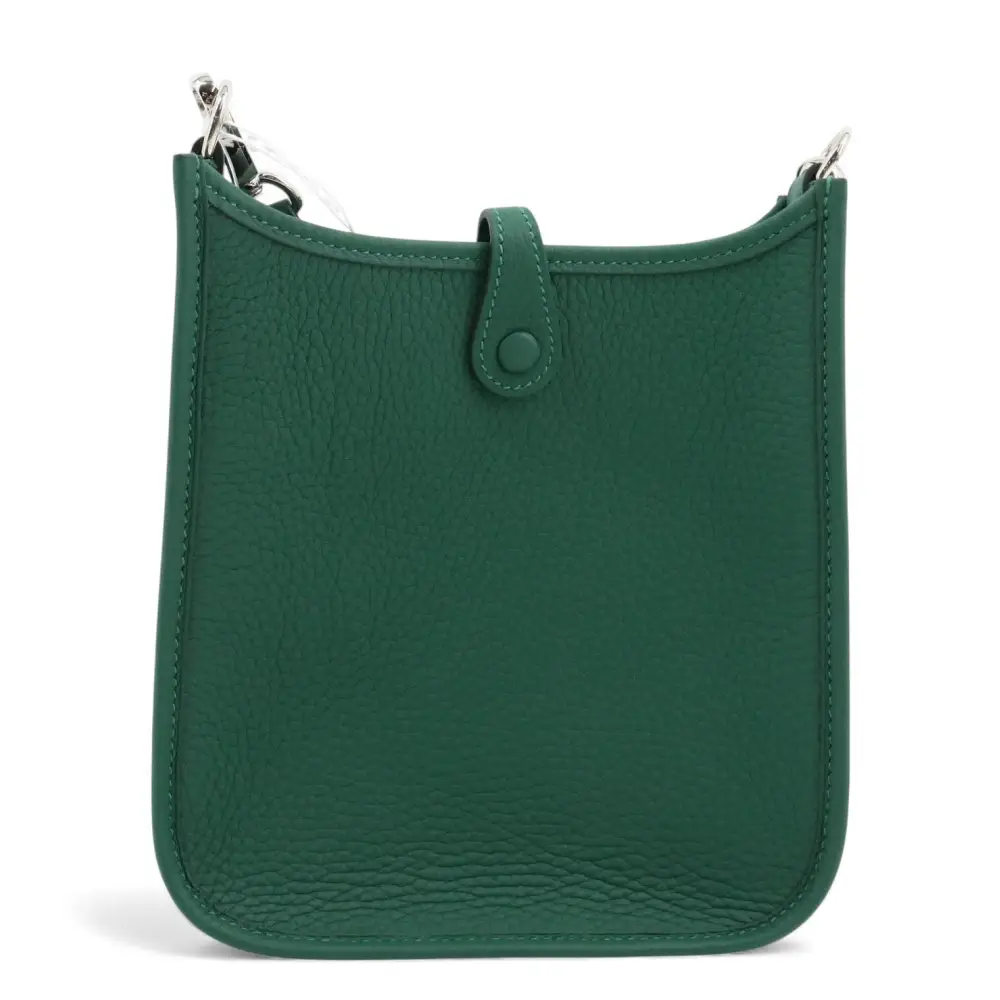Green leather handbag with a strap on a white background