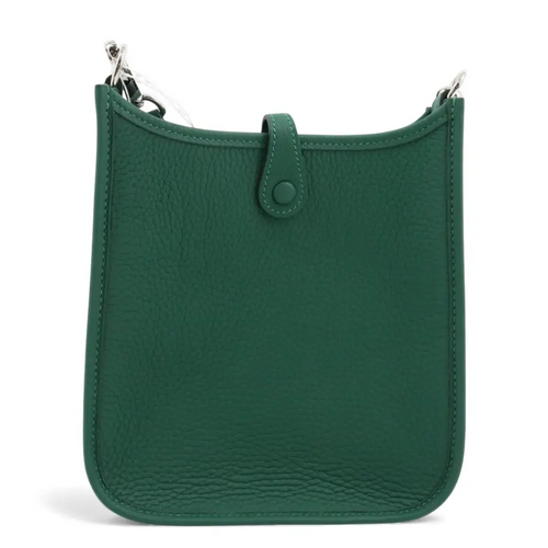 Load image 1 in gallery view. Green leather handbag with a strap on a white background