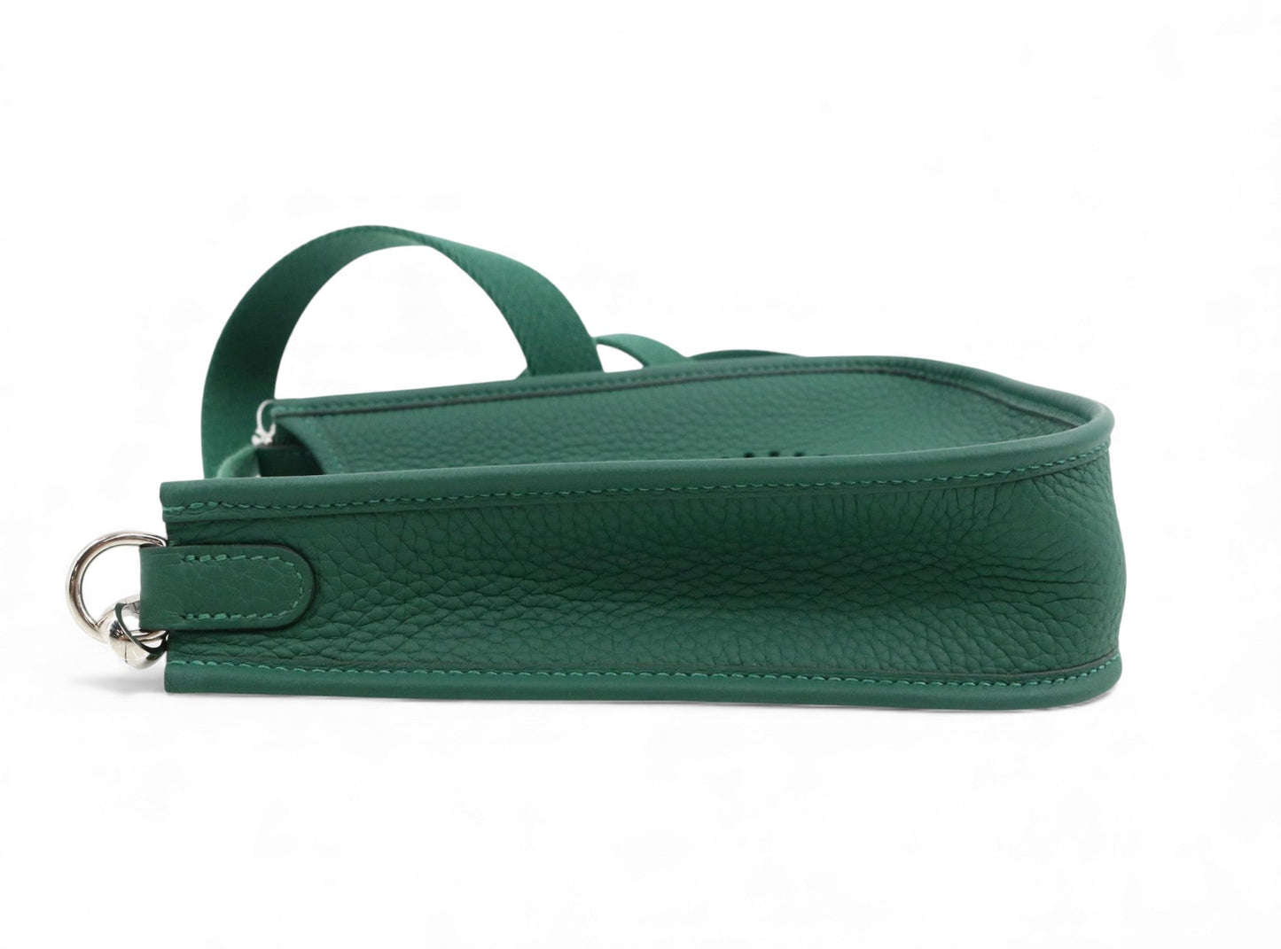 Green leather handbag with a strap on a white background