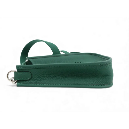 Load image 1 in gallery view. Green leather handbag with a strap on a white background