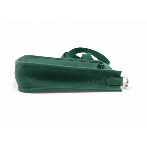 Load image 1 in gallery view. Green handbag with a strap on a white background