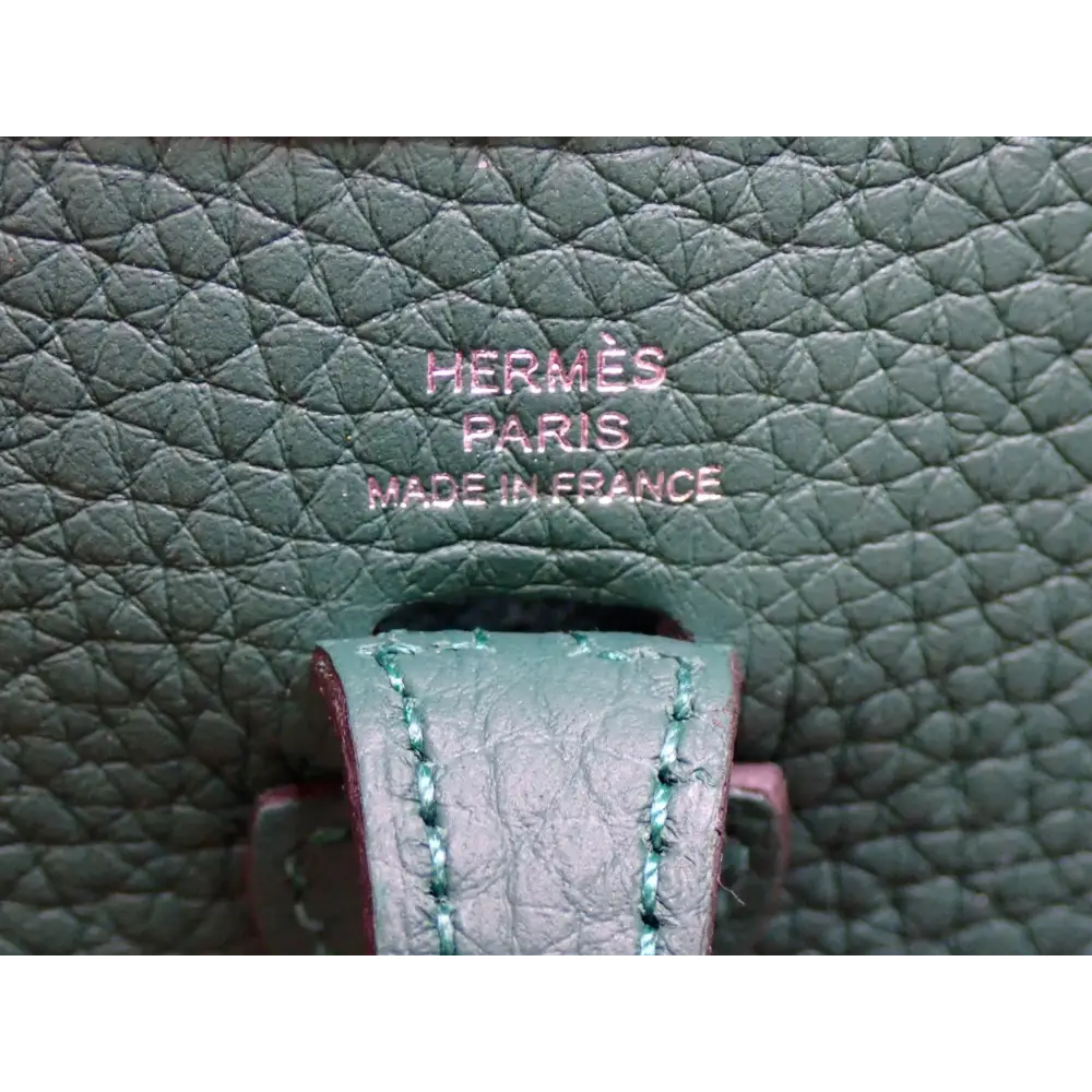 Close-up of a green leather Hermès bag with 'Made in France' text.